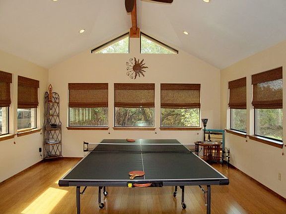 Enormous game room or second living with three walls of windows.