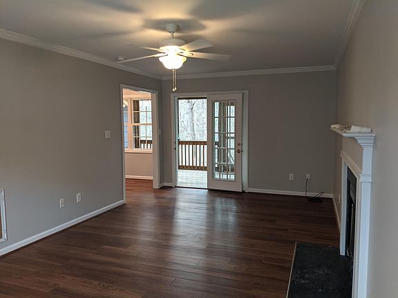 Living room opens to screened in porch. Double windows in back left are part of the breakfast nook in the kitchen