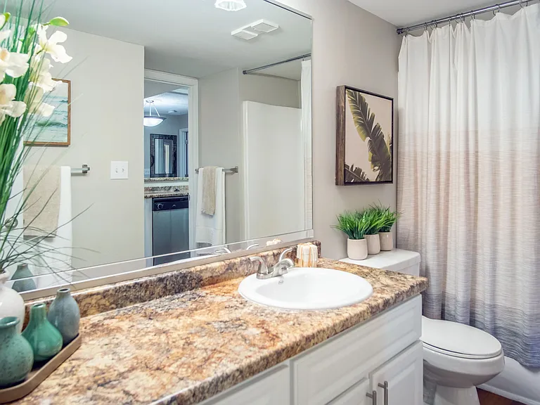 Feel like royalty in our spacious ensuite bathrooms adorned with expansive granite-inspired countertops and illuminating vanity lighting.
