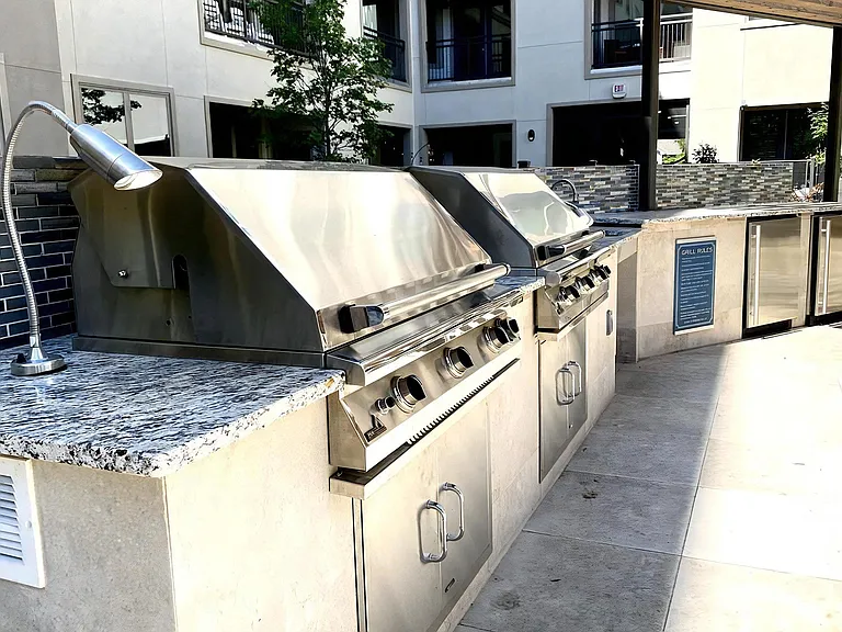 Stainless Steel Barbecue Grills with Tile Backsplash in Outdoor Kitchen