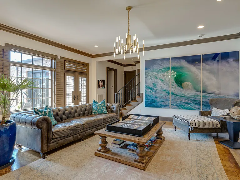 first floor living room with double french doors that lead to outdoor courtyard