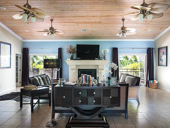 Large living room area with French doors leading to expansive outdoor balcony