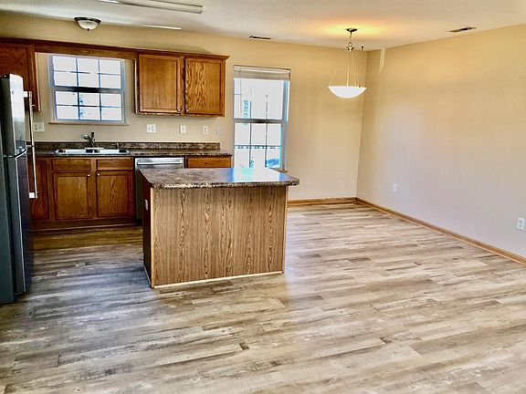 Another view of the kitchen, dining area and living space. Windows overlook garage and driveway to easily see who is visiting!