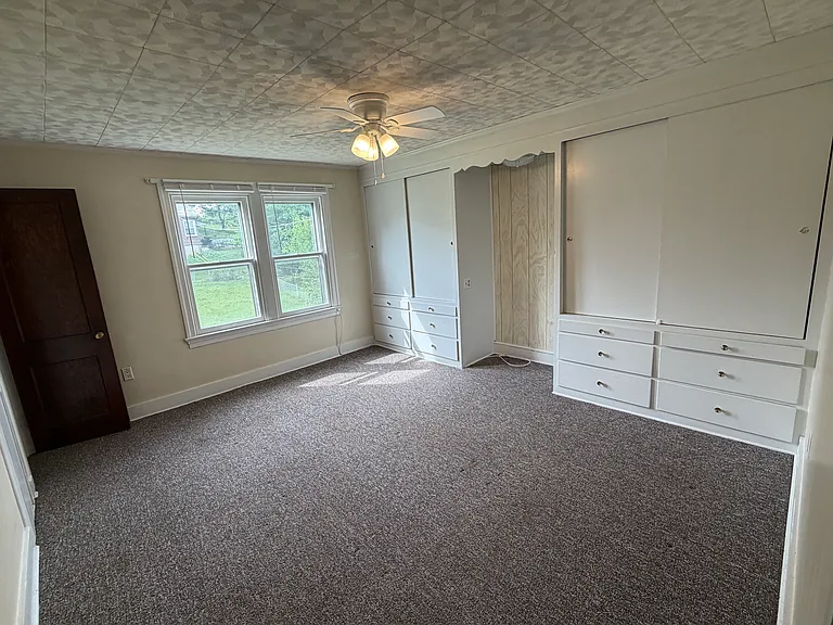 Rear bedroom is 15'x12' and features built-in his/her dresser drawers and hanging closet space.