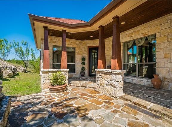 Inviting entry has covered porch where you can relax and enjoy the peaceful surroundings.