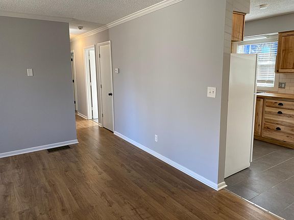living room looking into kitchen and hallway