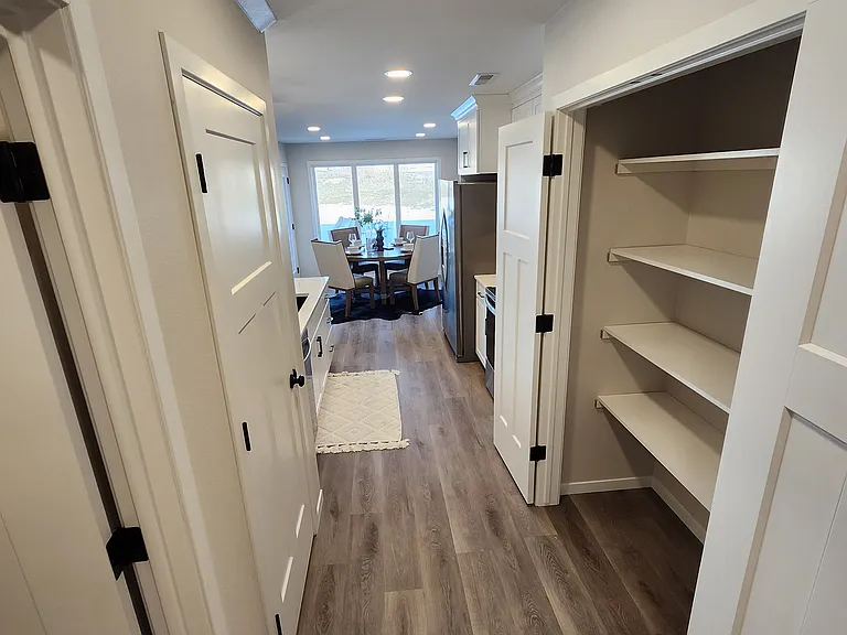 Pantry off the hallway from the garage entrance into kitchen. (Pictures are of another unit with similar finishes and features.)