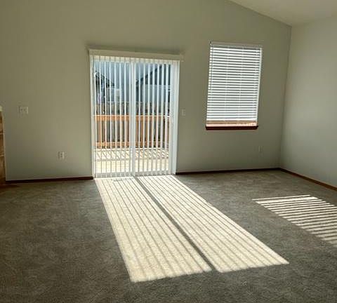 Living area with slider view to deck and backyard