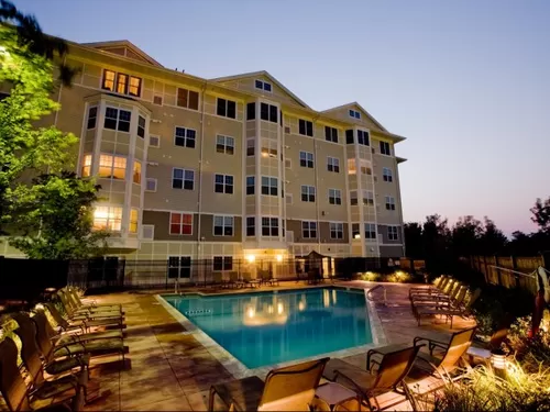 Exterior View of Pool and Apartments at Night - Canton Woods