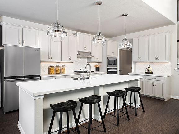 Large kitchen with walk in pantry, ample counterspace and kitchen island.