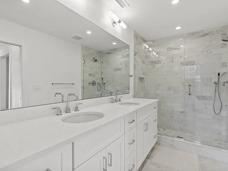 Primary bathroom with full length, double sink vanity.