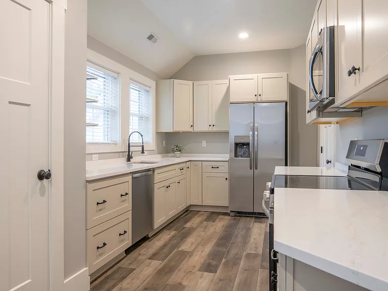 Kitchen with brand-new stainless steel appliances.
