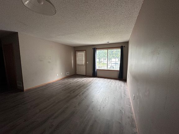 Main-level living room with large picture window and private side entrance
