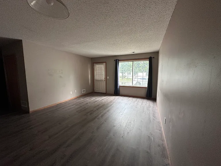 Main-level living room with large picture window and private side entrance