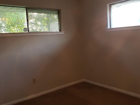 second bedroom with carpet and ceiling fan