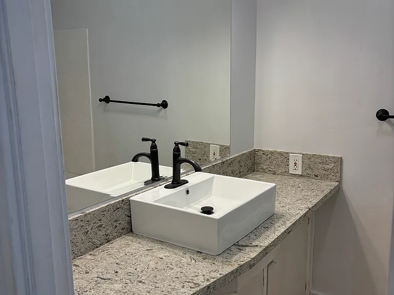 Master Bedroom and Bathroom with toilet, sink, cabinetry and shower.