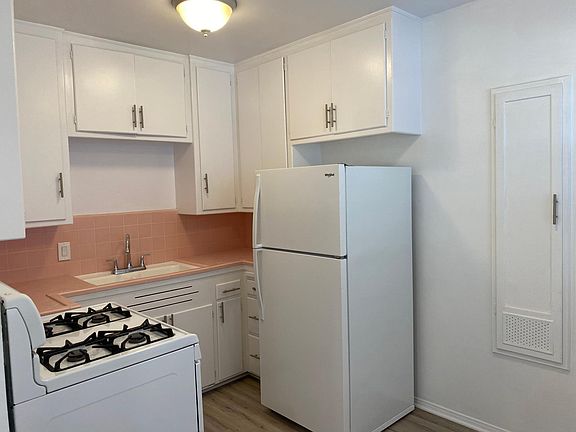 Charming eat-in kitchen which includes a gas stove and refrigerator.