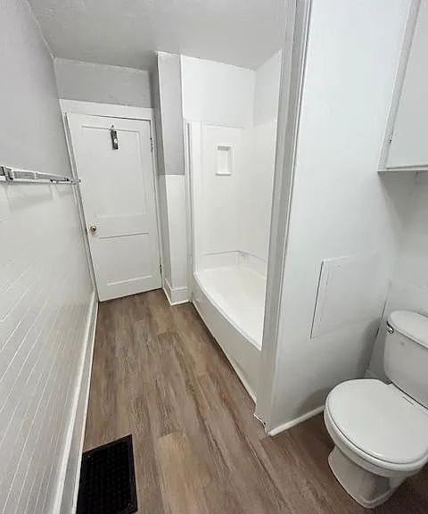 Standing at the counter looking towards the shower stall and door.