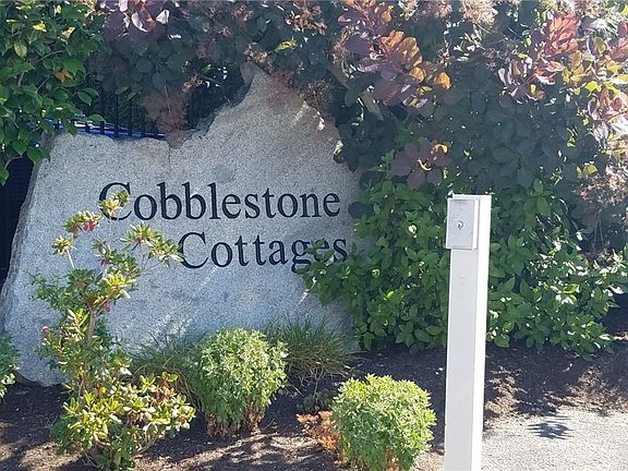Beautiful entry into Cobblestone Cottages community with Herringbone paved circular drive around a soothing water feature.