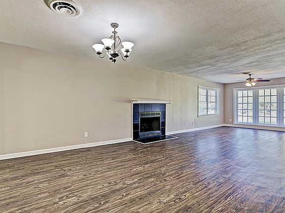 Very spacious living room with beautiful windows bringing in natural light