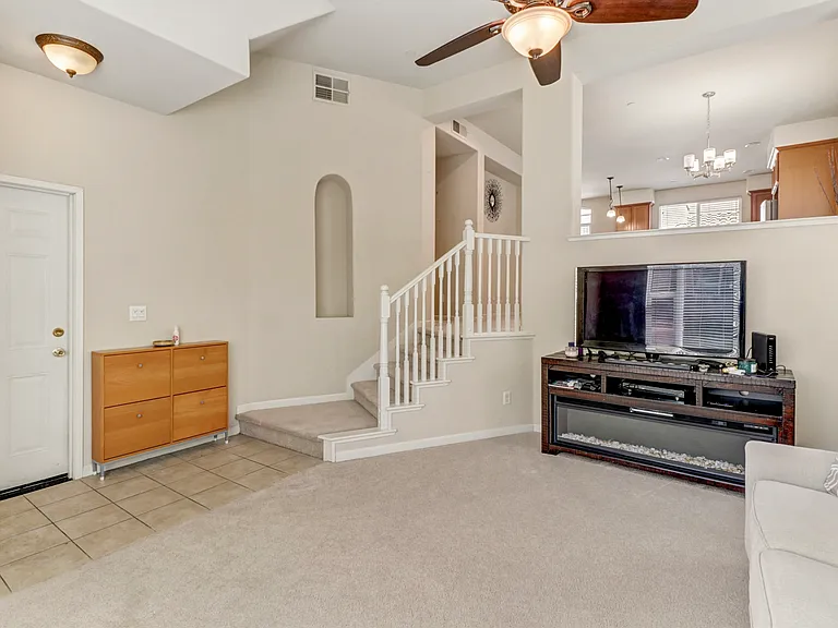Sunken Living Room (garage entrance door) and stairs to Dining area and kitchen