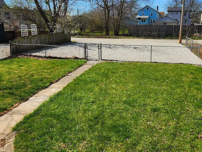 Fenced back yard and newly graveled off-street parking, two spaces per unit.