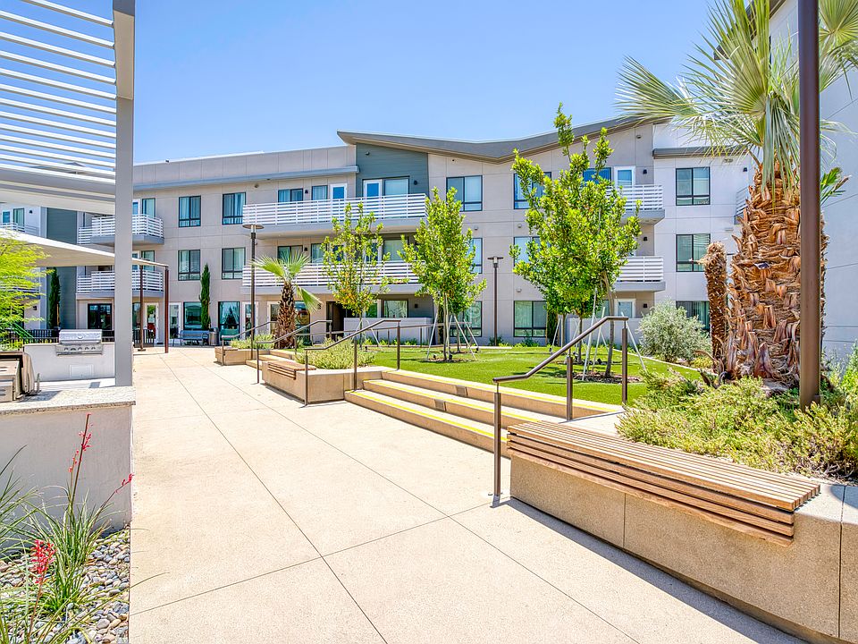 Modern courtyard with open-air seating and lush landscaping.