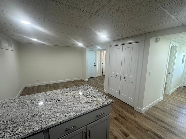 View into Living Room from kitchen. Large pantry closet