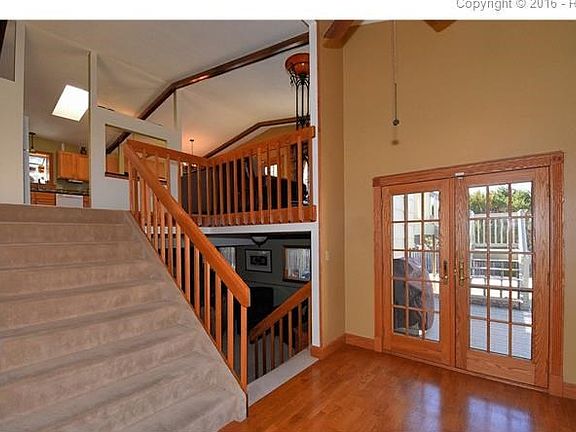 Open foyer with hardwood flooring and French doors to rear yard.