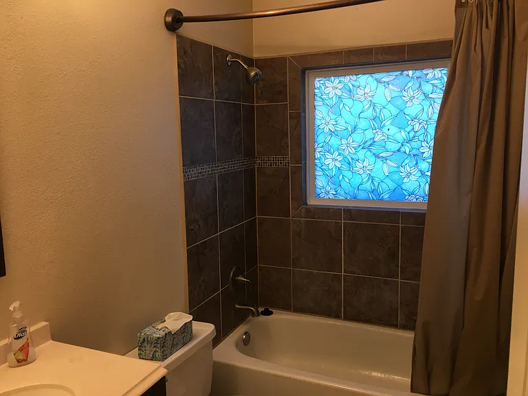 Upstairs full bath with art window.