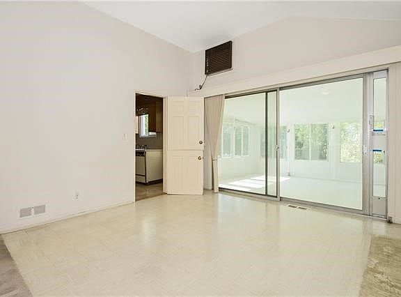 Dining room with door to kitchen open and sliding door to the 3 season room