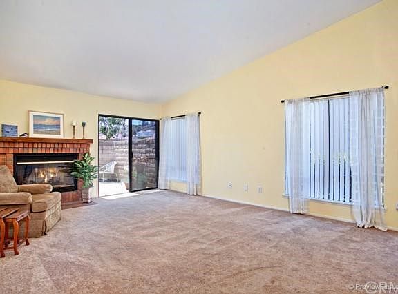 Large living room with cozy fireplace and access to the entertainers patio.