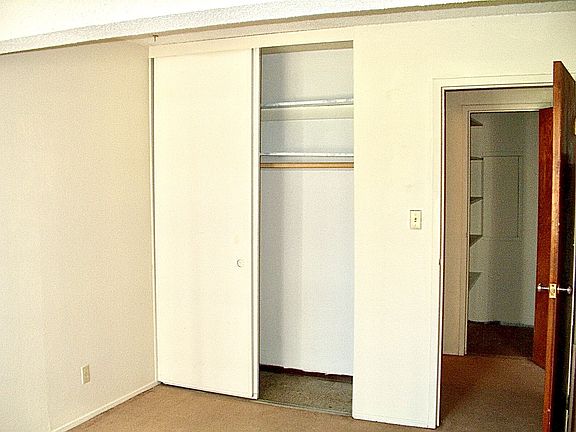bedroom closet and pantry/storage in the hallway