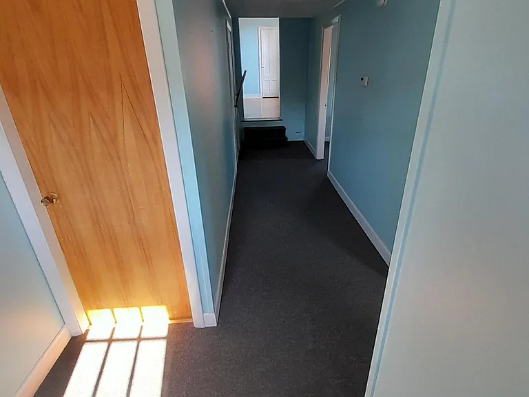 Storage room door and hallway seen from back door