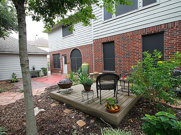 A BEAUTIFUL DECK NESTLED IN THE BACKYARD