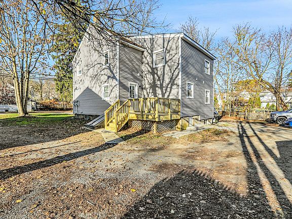 Back of house view: porch, driveway