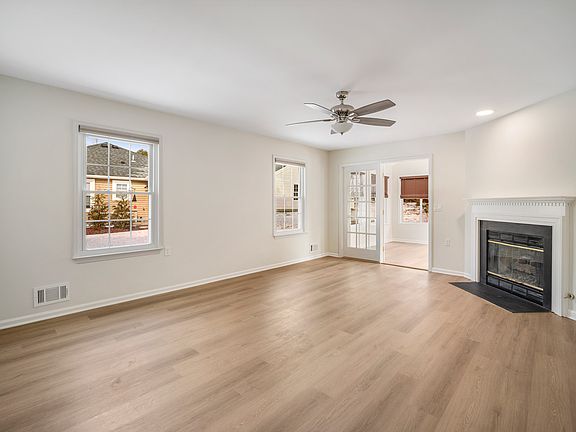 Livingroom with fireplace opens to sunroom