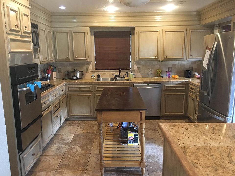 Large kitchen with gas stove and stainless steel appliances