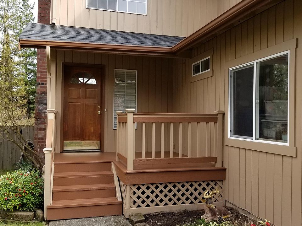 front door with porch and side of double garage