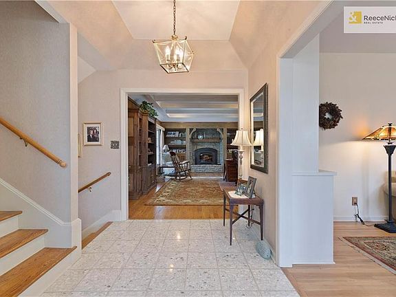A light and airy foyer draws the eye to the cozy hearth room and the family room just to the right.
