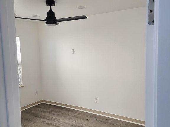 Downstairs bedroom with new ceiling fan and closet space.
