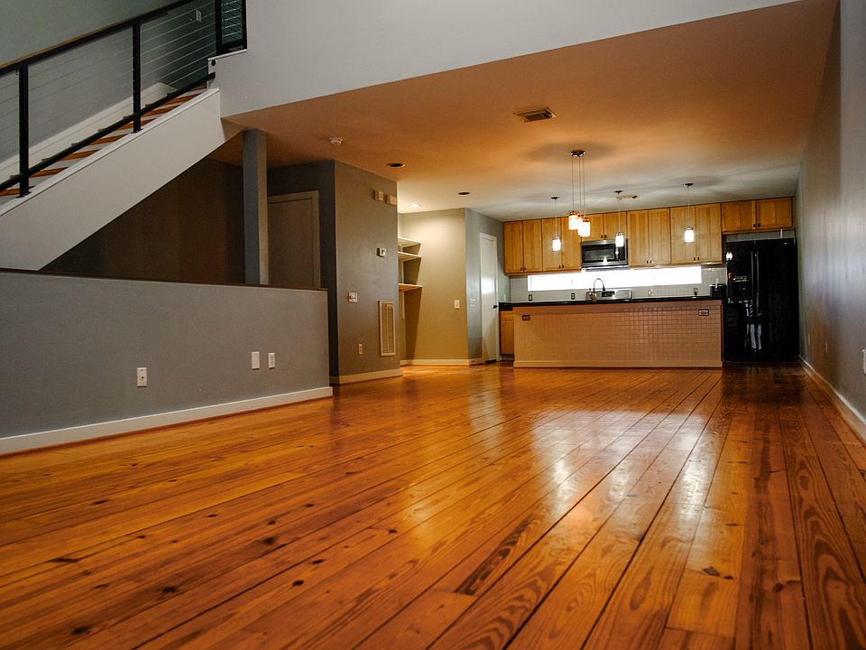 Well appointed living room and dinning room looking into Kitchen with real wood floors.
