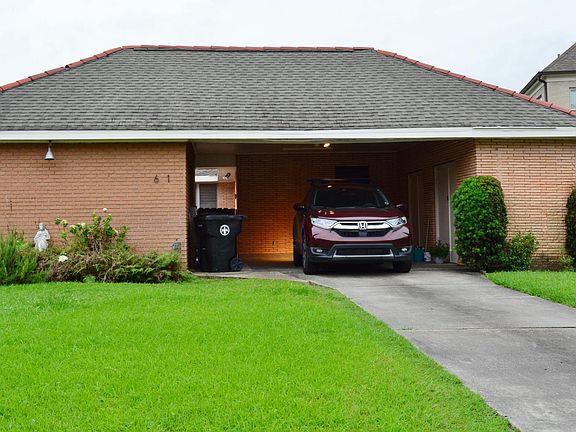 Street view, apartment on left side of carport