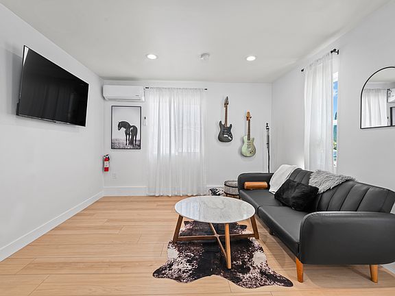 65 inch TV mounted to wall. Couch and furniture stay in rental.