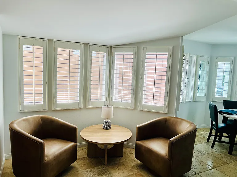 Swivel chairs serve as a lounging area off the living room but swivel to chat with those in the kitchen