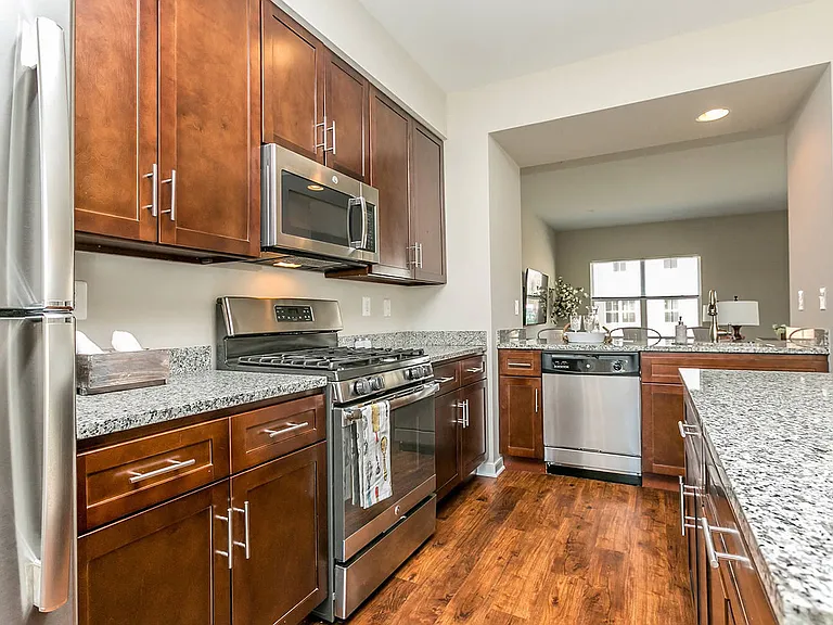 Beautiful, gourmet kitchens featuring granite, stainless steel appliances including gas range
