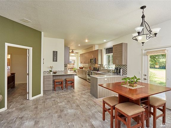 AS you come in further the master bedroom is on the left, the dining area with access to the back patios is on your right - the kitchen is next