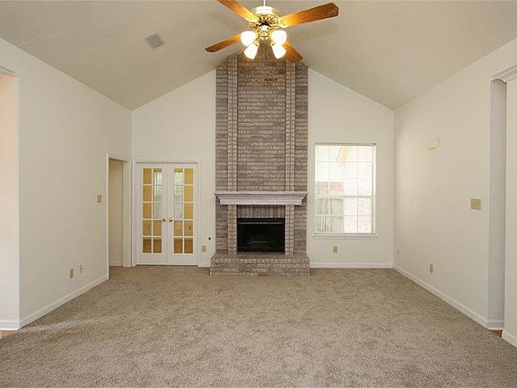 Spacious den with cathedral ceilings and fireplace