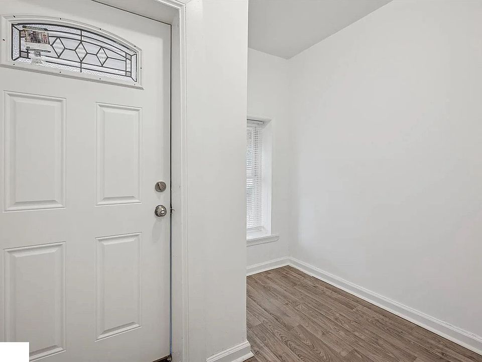 Clean and bright entry area with wood-style flooring and natural light. This space serves as a convenient spot for receiving packages and adds an extra layer of security before entering the main living areas.