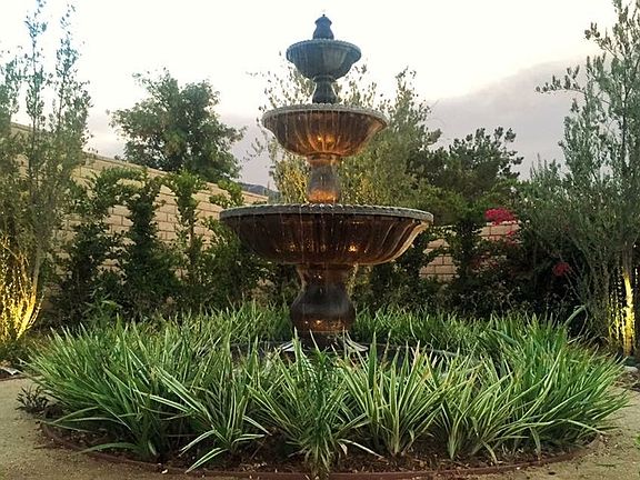 Front yard fountain with beautiful gardens